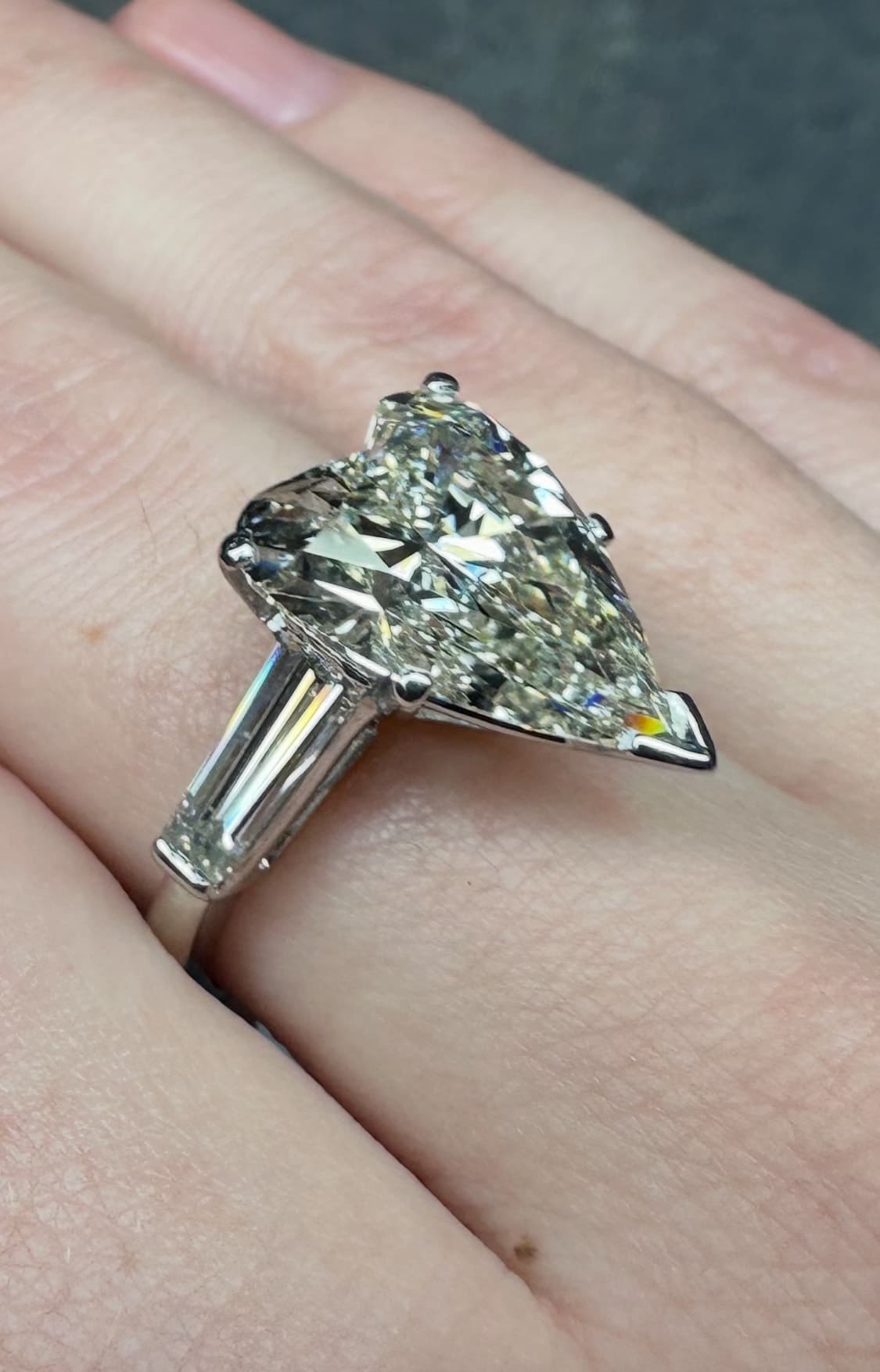 Pear-shaped diamond solitaire with tapered baguette side stones, sourced by Cool Blue Diamond