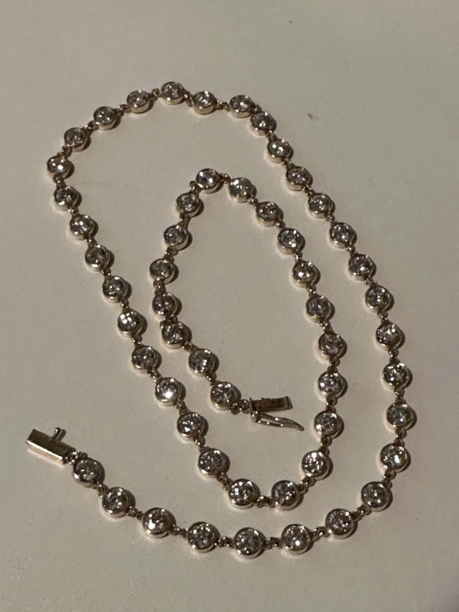Bezel-set diamond station necklace — round brilliants set continuously in white gold