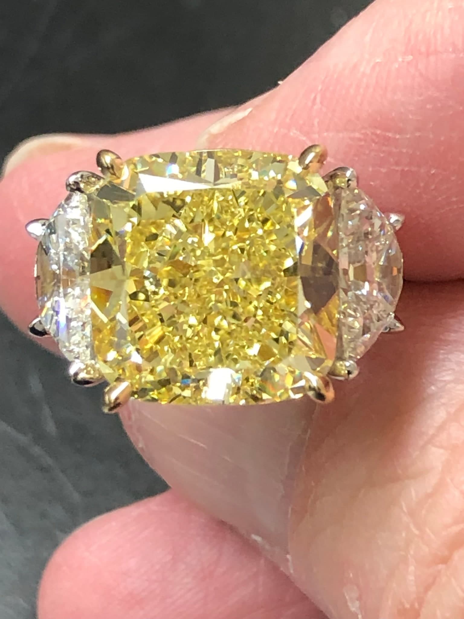 Canary yellow cushion-cut diamond three-stone ring with crescent moon side stones