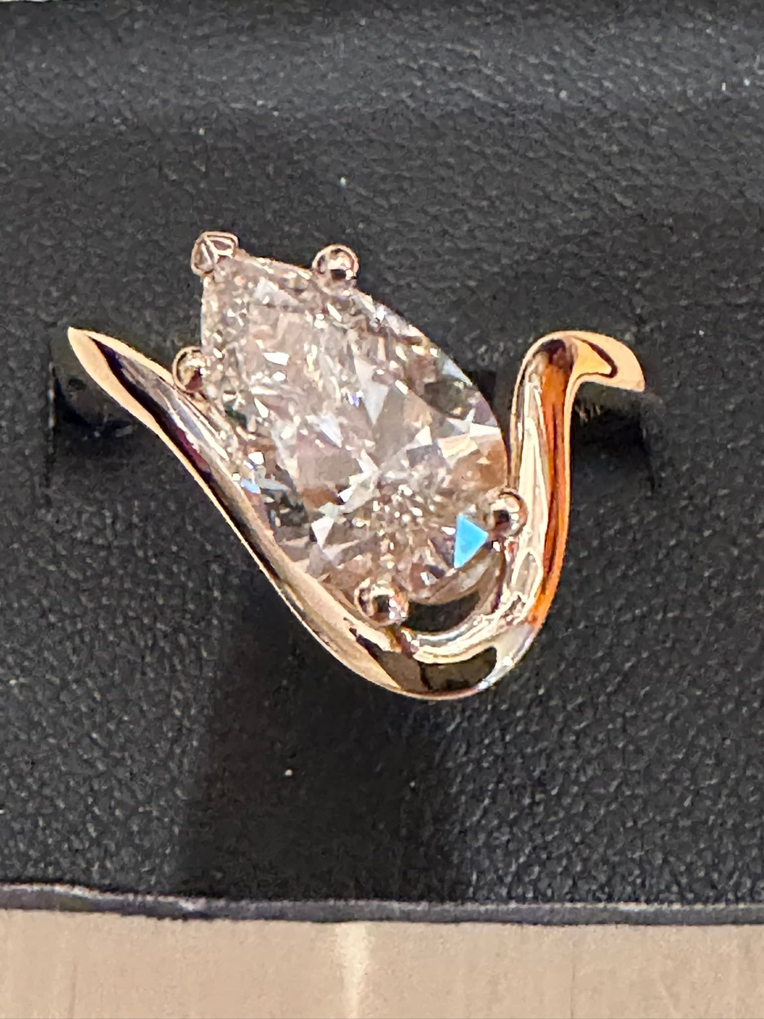 Pear-cut diamond in a sweeping rose gold setting